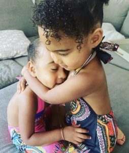 Two children hugging and supporting each other. If your child is struggling with the effects of childhood trauma, therapy for children in Los Angeles can help.