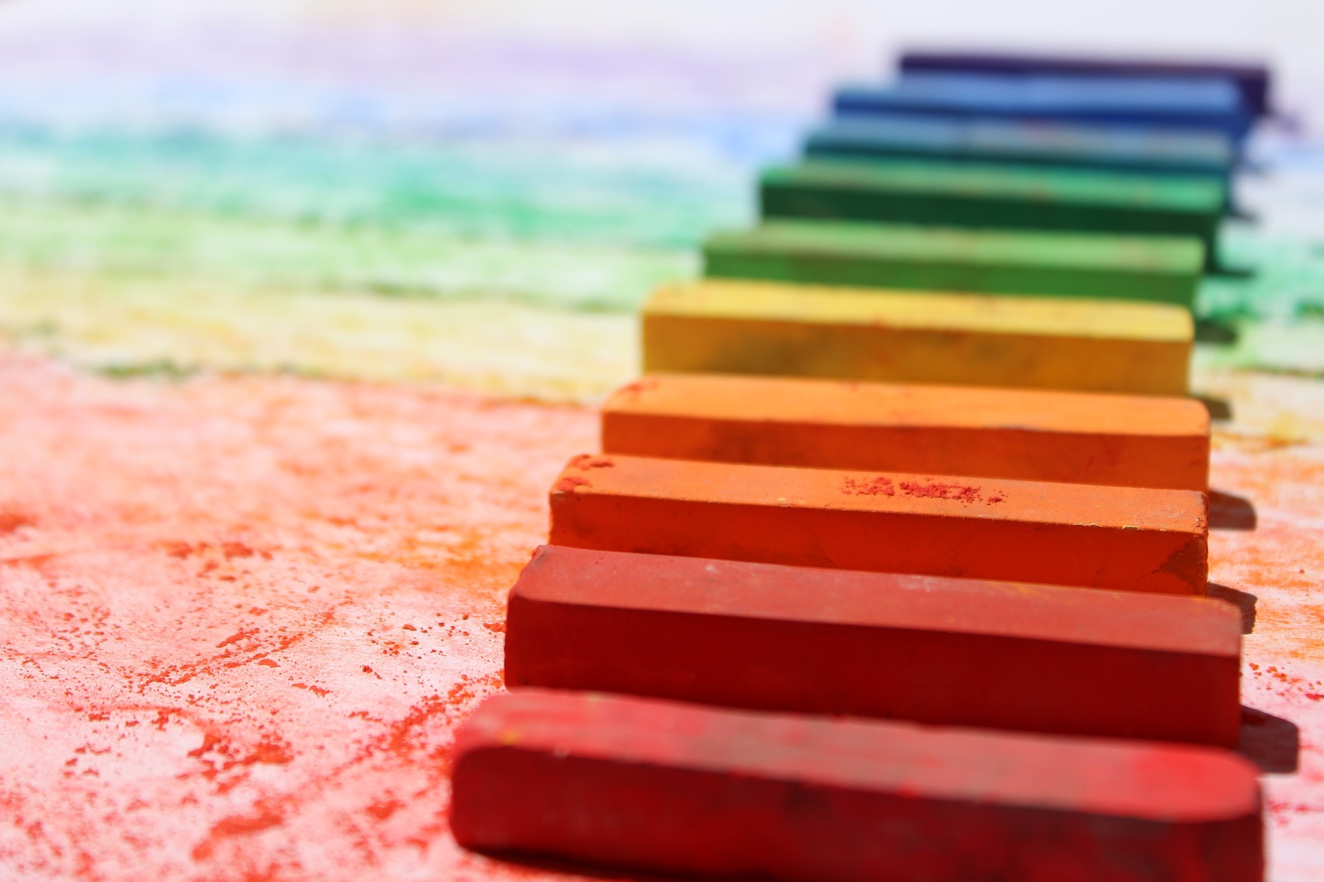 Colorful chalk arranged in a rainbow representing the LGBTQ+ youth community. Our LGBTQ+ Youth Proccess Group Therapy in Pasadena, CA is here to help support youth.
