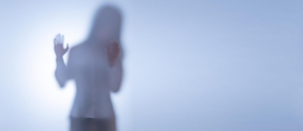 Woman standing in a fog representing the disconnected feelings that come with trauma. Work through these feelings and clear your mind with therapy for trauma in Pasadena, CA. Learn more today.