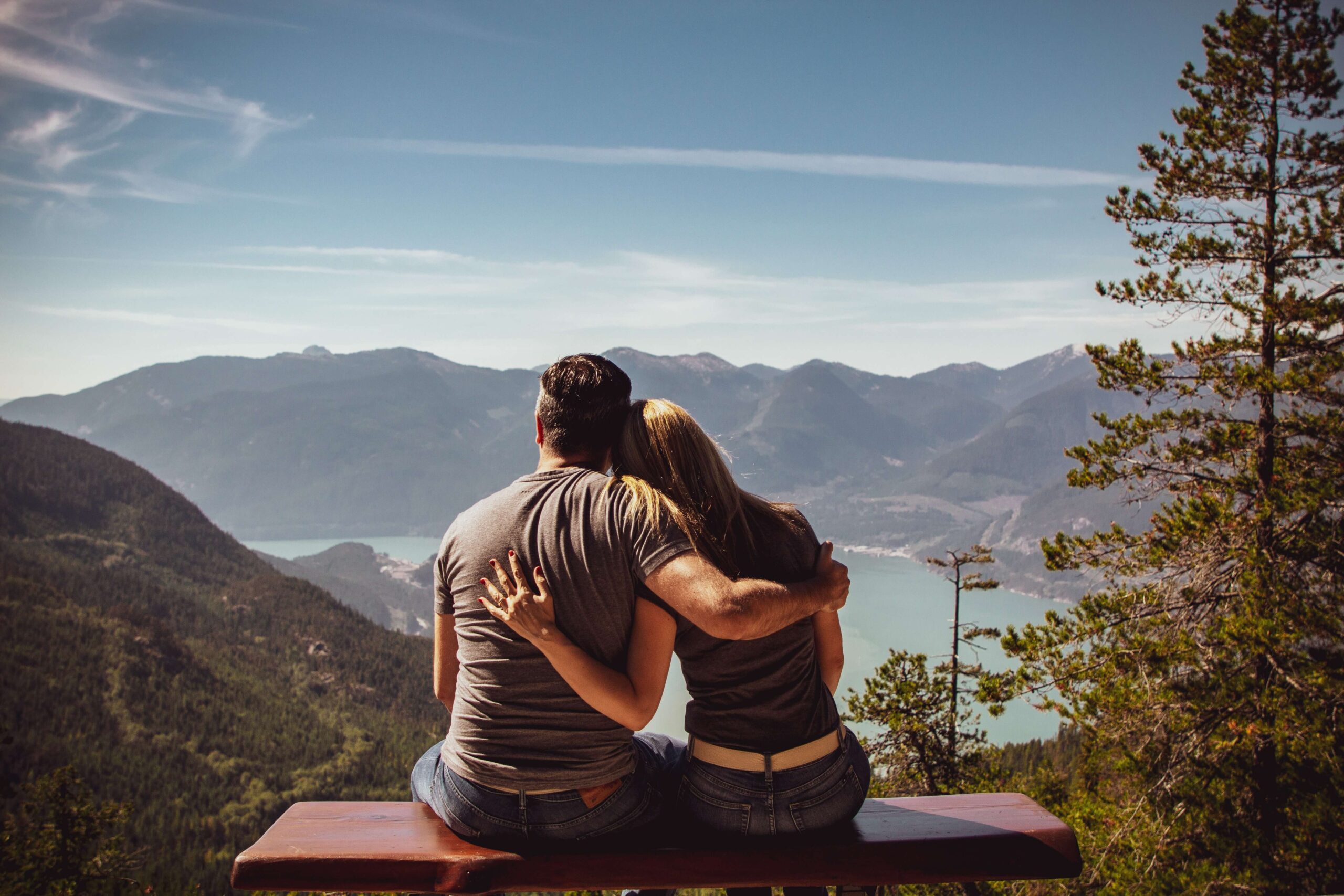 A couple embraces as they overlook the mountains in front of them. Strengthen your relationship in Couples Therapy in Pasadena, CA.