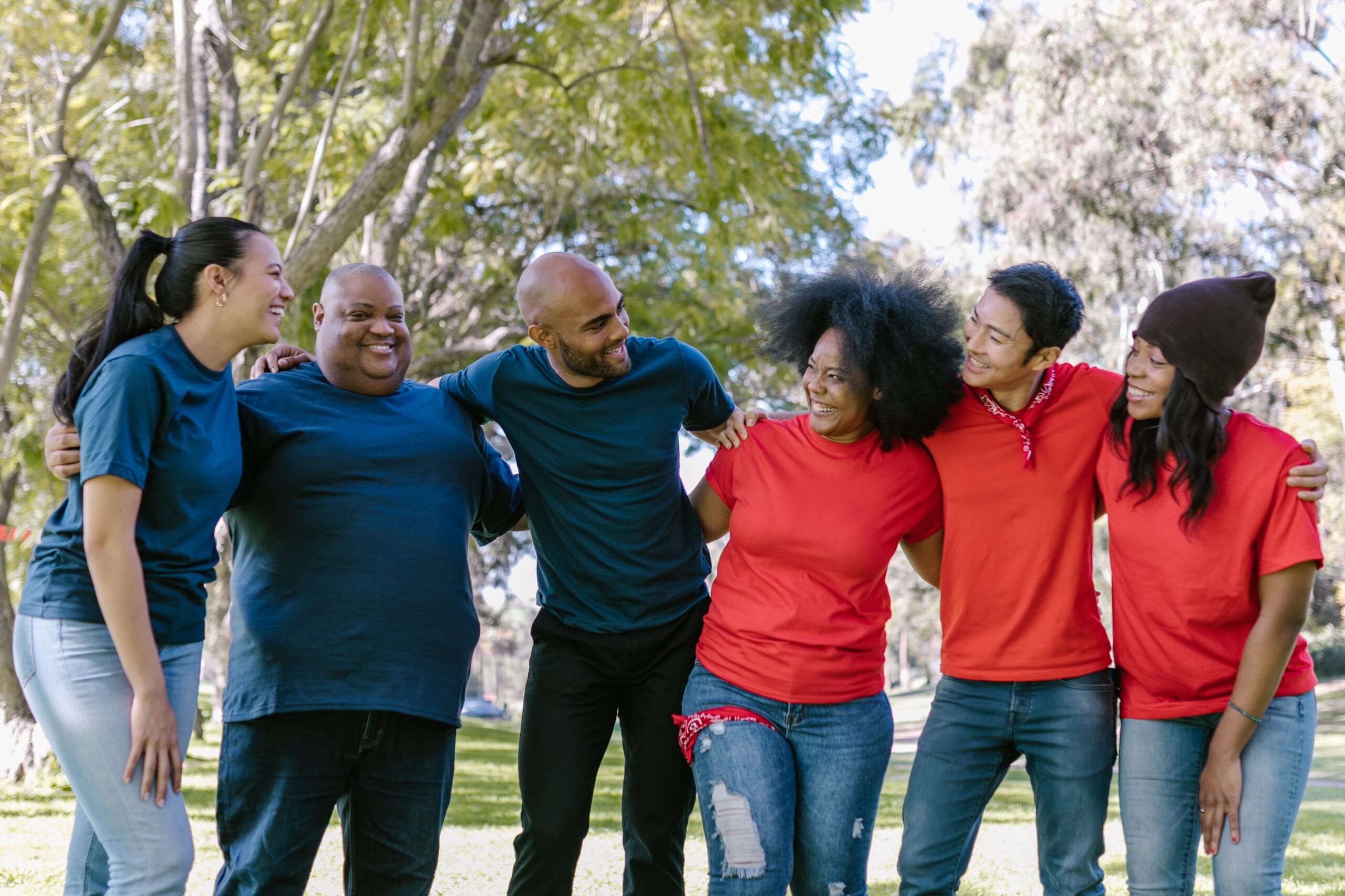 A group of people stand with their arms around each other showing support for each other's journey to self-understanding through Internal Family Systems Therapy in Pasadena, CA. 